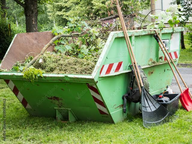 Skip bin filled with garden branches and green waste in Dubai