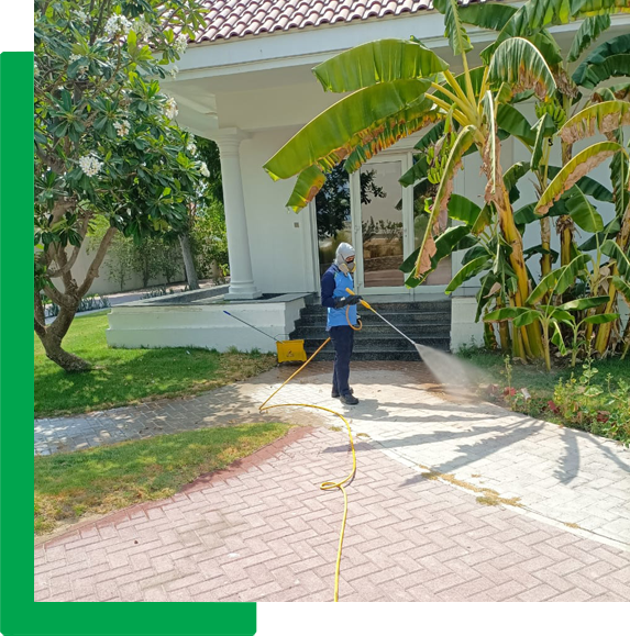 Pressure washing a villa garden walkway in Dubai